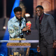 Chadwick Boseman, winner of the Best Hero award for Black Panther, presents his trophy to James Shaw Jr. onstage during the 2018 MTV Movie & TV Awards at Barker Hangar on June 16, 2018, in Santa Monica, Calif.